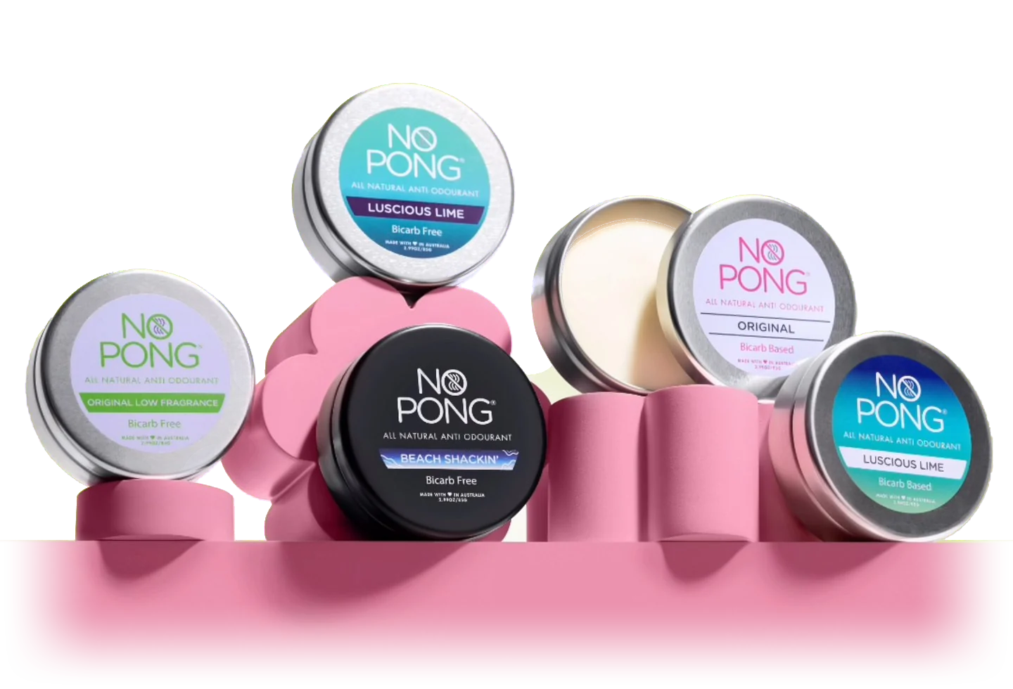 Award-winning No Pong natural deodorant tins on a pink shelf: Original Low Fragrance, Luscious Lime, Beach Shackin’, Original and Luscious Lime Bicarb Based, plus one open tin